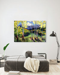 Painting of a forest scene on a wall above a bed in a bedroom.