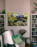 Living room with a gray sofa, bookshelf, and decorative items.