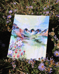 A colorful art print featuring a stylized landscape with mountains and floral elements in the foreground.