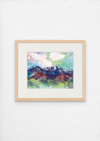 Colorful acrylic painting of a mountain and some red rock formations in the foreground on a topographic map, framed on a white wall.