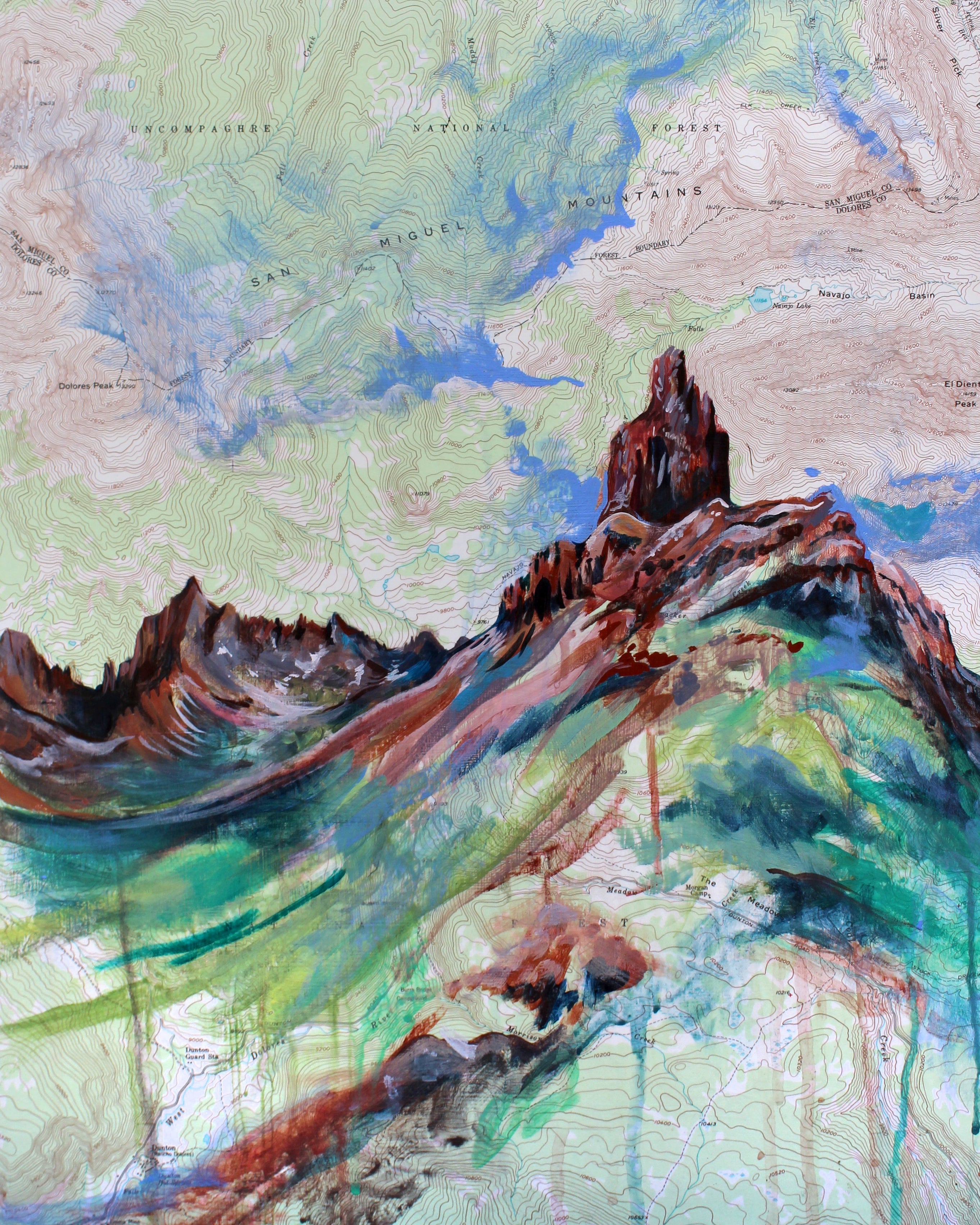 An art print featuring a colorful acrylic painting over a topographic map background, with peaks and a mountain in the foreground.