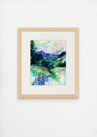 Framed painting of a landscape with trees and flowers on a white wall