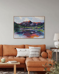 Living room with a brown sofa, decorative pillows, and a colorful mountain landscape painting on the wall.