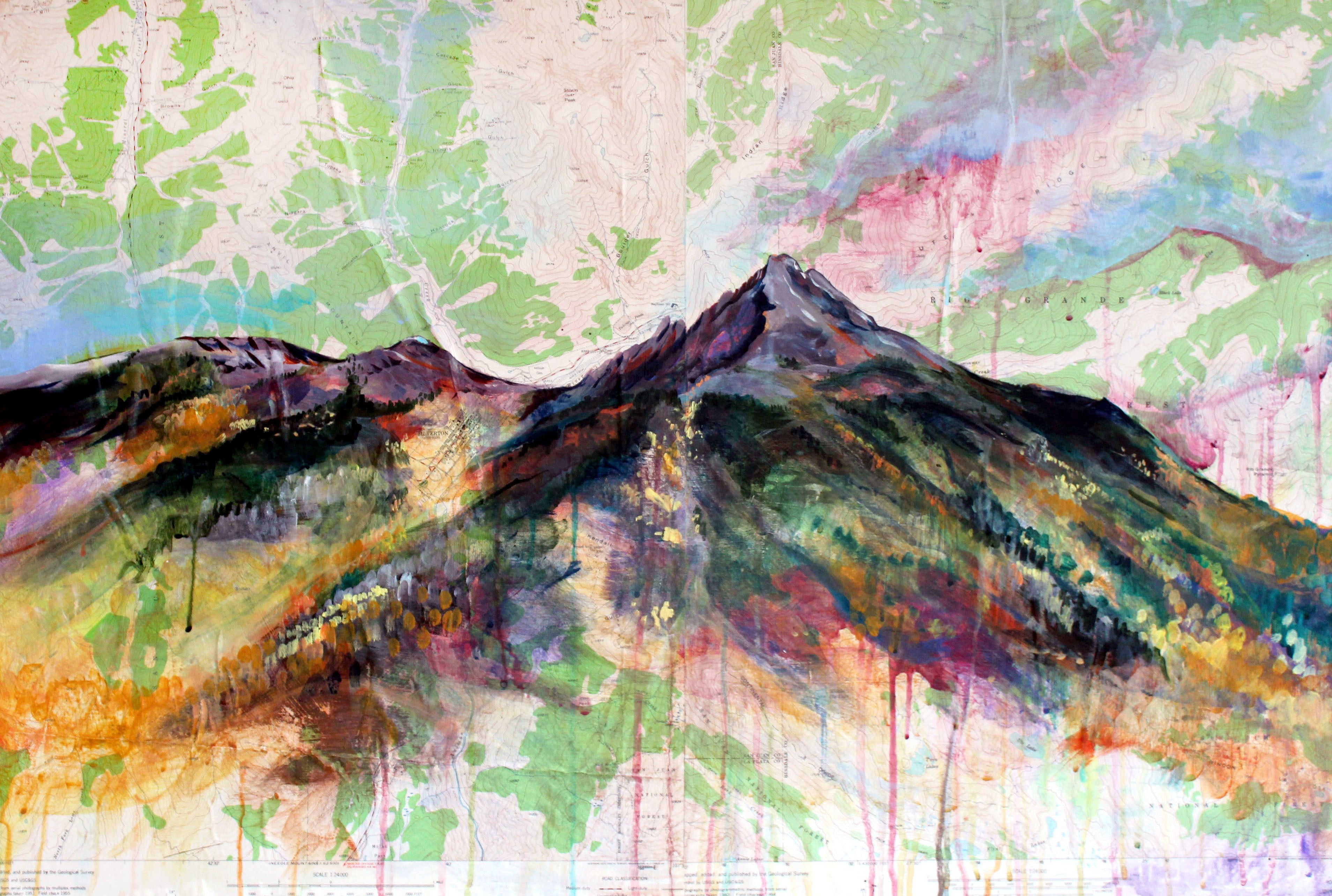 A colorful acrylic painting of a mountain on a USGS topographic map.