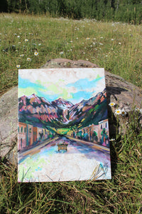 Painting of a mountainous landscape with buildings on a rock in a grassy field