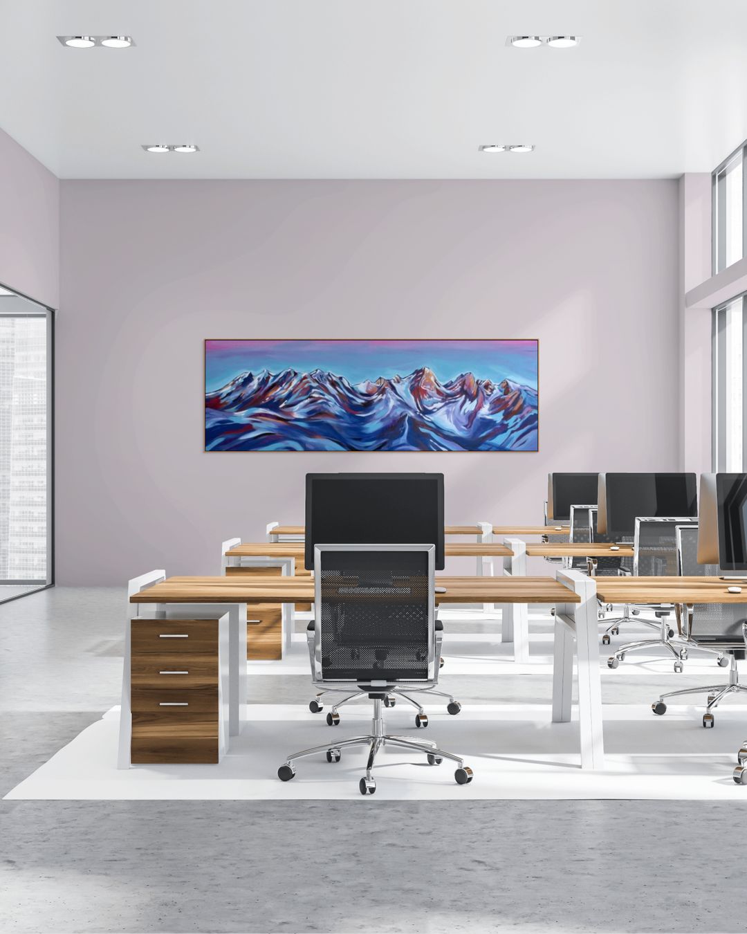 Modern office setup with desks, chairs, and a large acrylic painting displaying a mountain landscape.