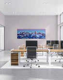 Modern office setup with desks, chairs, and a large acrylic painting displaying a mountain landscape.