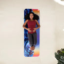 A woman lying on a colorful yoga mat. 