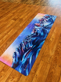 Yoga mat with artistic design on a wooden floor