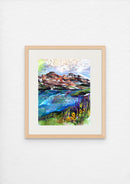 Framed painting of a mountain landscape on a white wall