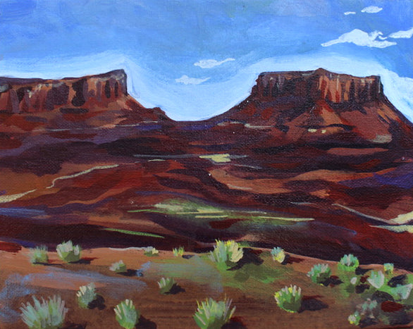 Painting of desert landscape with red rock formations and blue sky.
